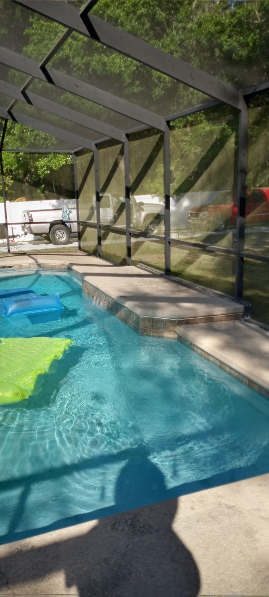 Residential pool deck and screened outdoor area in Central Florida