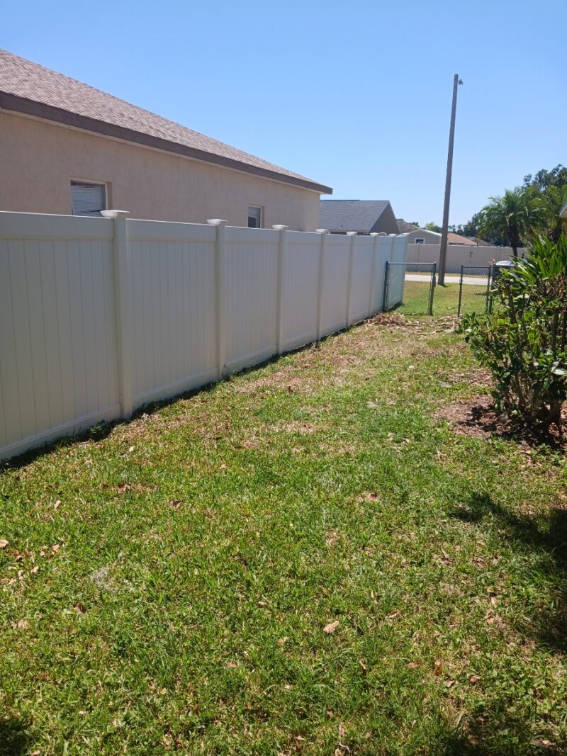 Clean white vinyl fence at a residential property in Central Florida